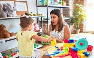 teacher playing with kid montessori education