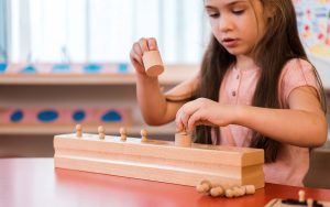 student playing at a montessori school