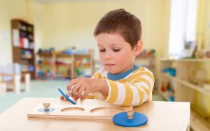 student playing at montessi school