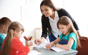 teacher with kids at montessori school