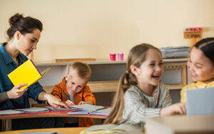 teacher working with kids at school