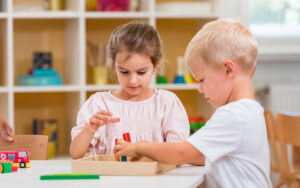 children playing with colorful wooden toys