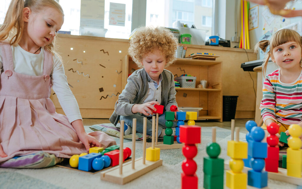 Preschool students sorting wooden geometric toy balls