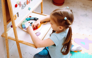 girl playing with blocks at a school