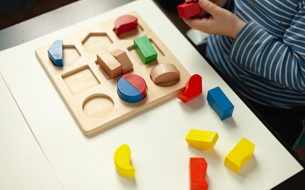kid playing with wooden blocks