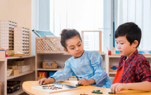 kids with wooden game at a montessori school