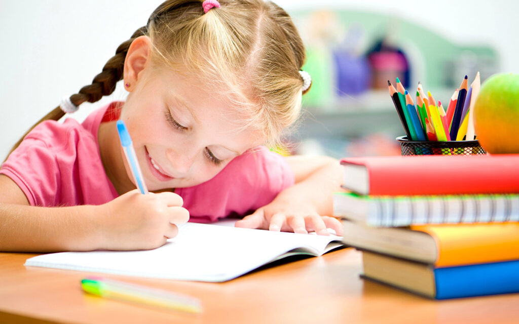girl smiling in her classrom