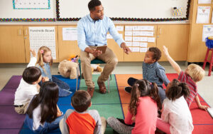 kids on the floor talking with teacher